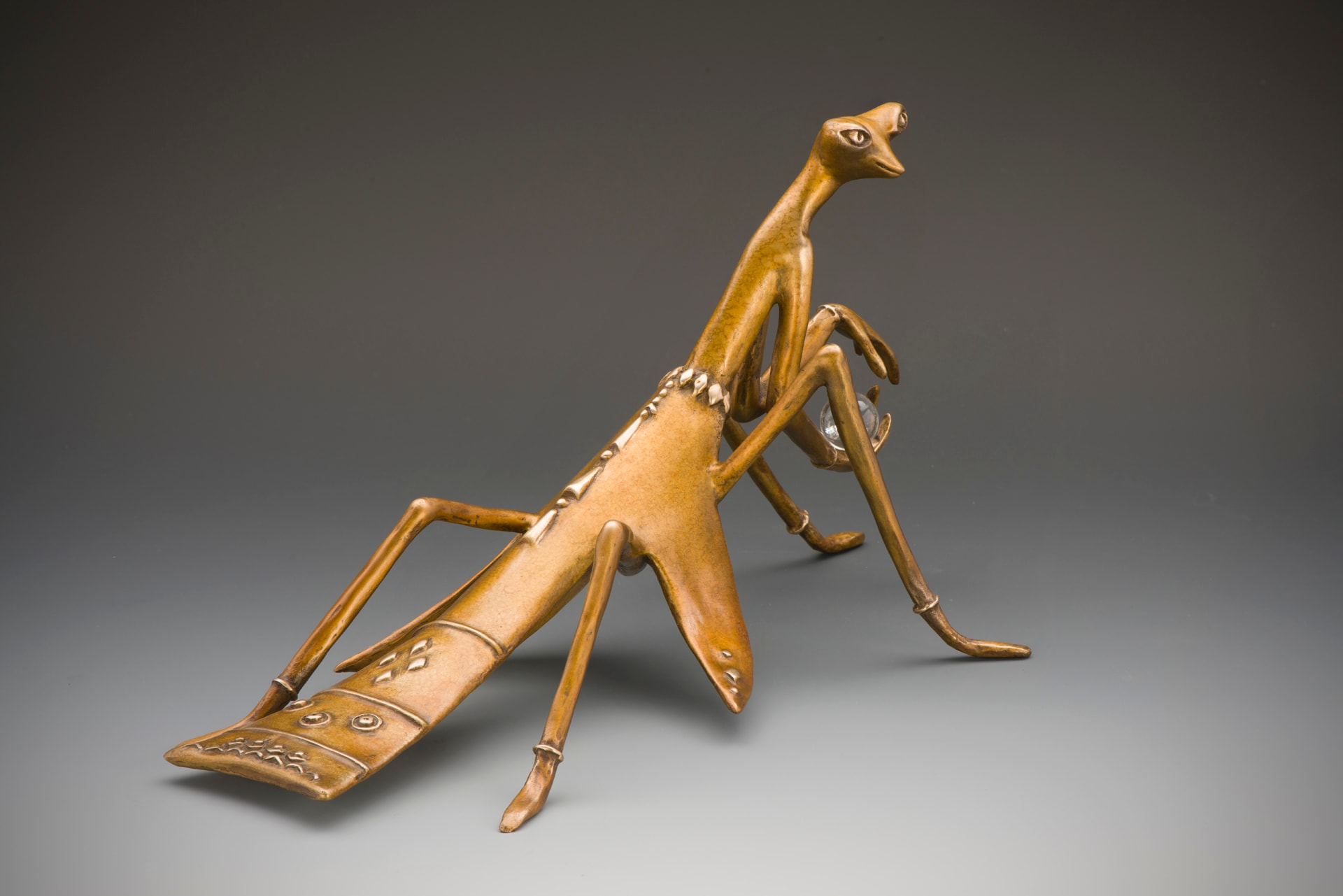 Rear three-quarter view of a Mantis Being sculpture